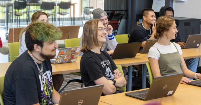 Students in classroom with laptops open