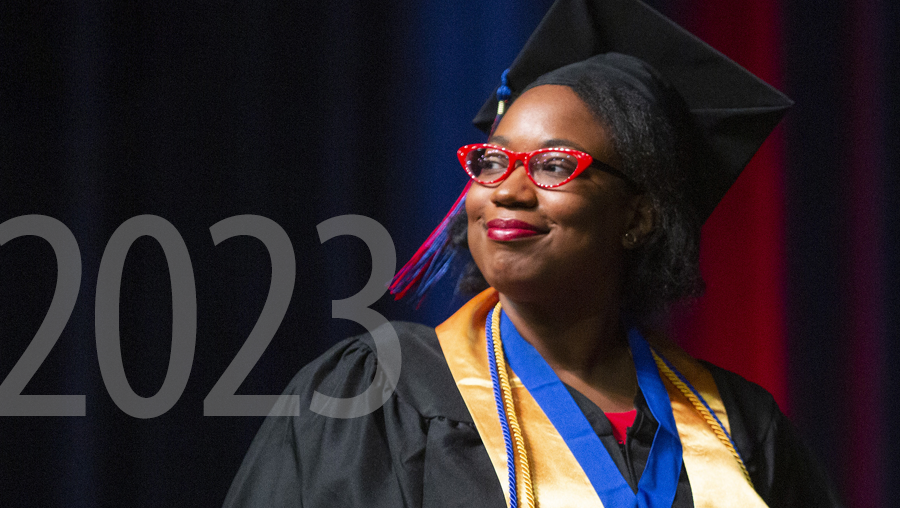 Photo of woman wearing commencement cap and gown.