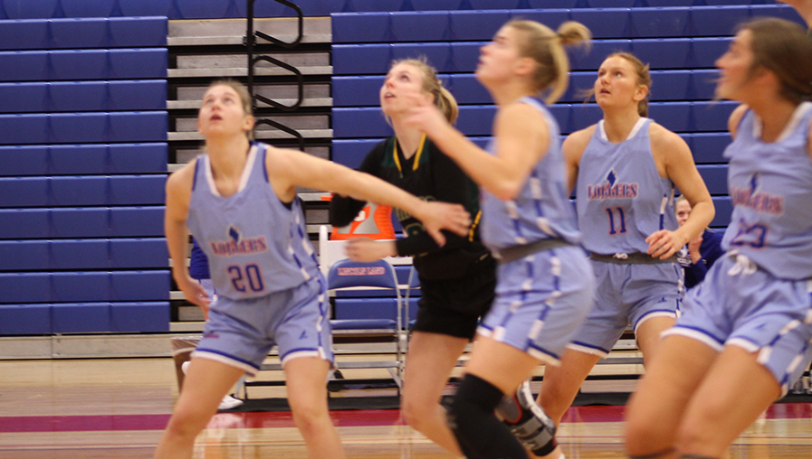 female basketball players ready to rebound ball