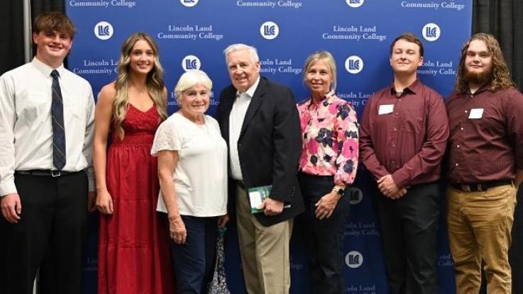 A group of students stand with their scholarship donor.