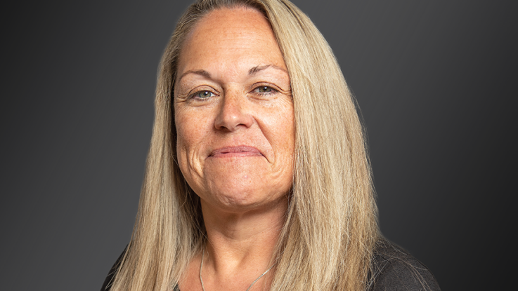 A woman with blonde hair and green eyes.