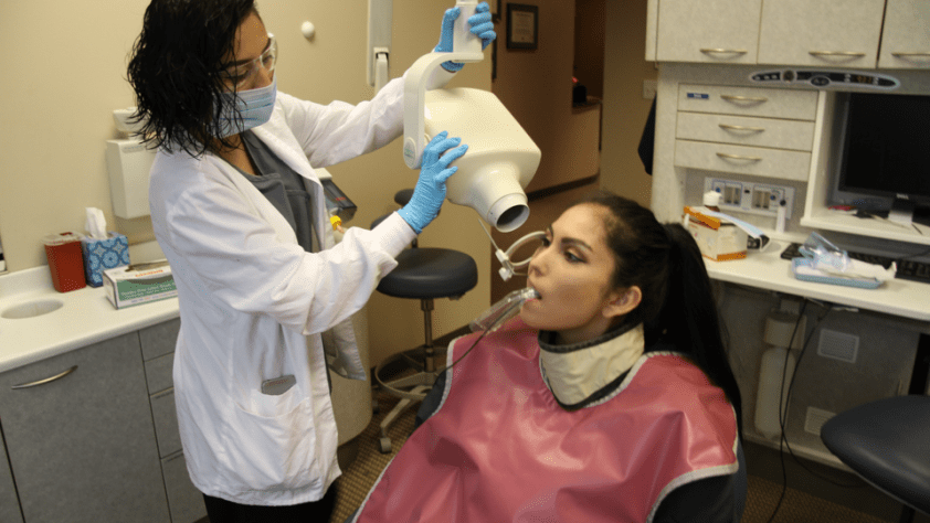 student with patient take xrays of teeth