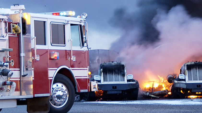 firetruck parked in front of vehicles that are on fire