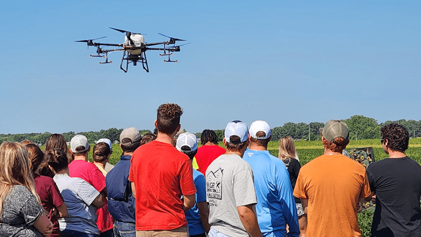 LLCC Ag students watching the Ag drone flying overhead.