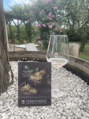 Terra Cruda Azienda Vinicola In Fratte Rosa (Best winery of Marche Region at Vinitaly "Gran Medaglia di Cangrande" sign with glass of wine and rose arbor in the background