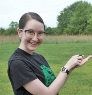 Student smiling and holding banded bird for release