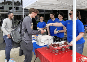 PTK members serving up hot dogs to students