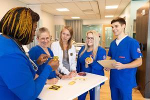 LLCC Nursing students use a nursing escape room in lab.