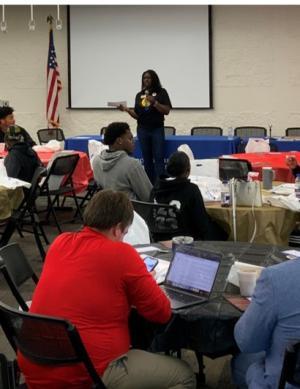 Woman presenting to a group of students.